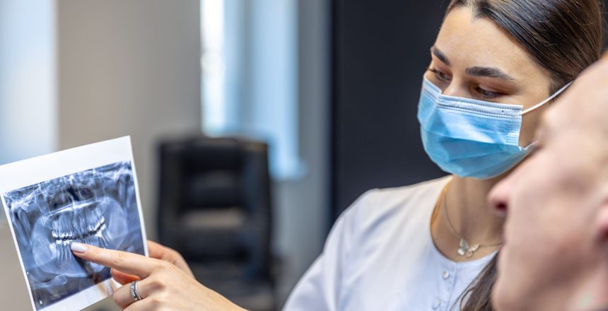 young-female-dentist-showing-patient-dental-xray-dentistry-concept (1)